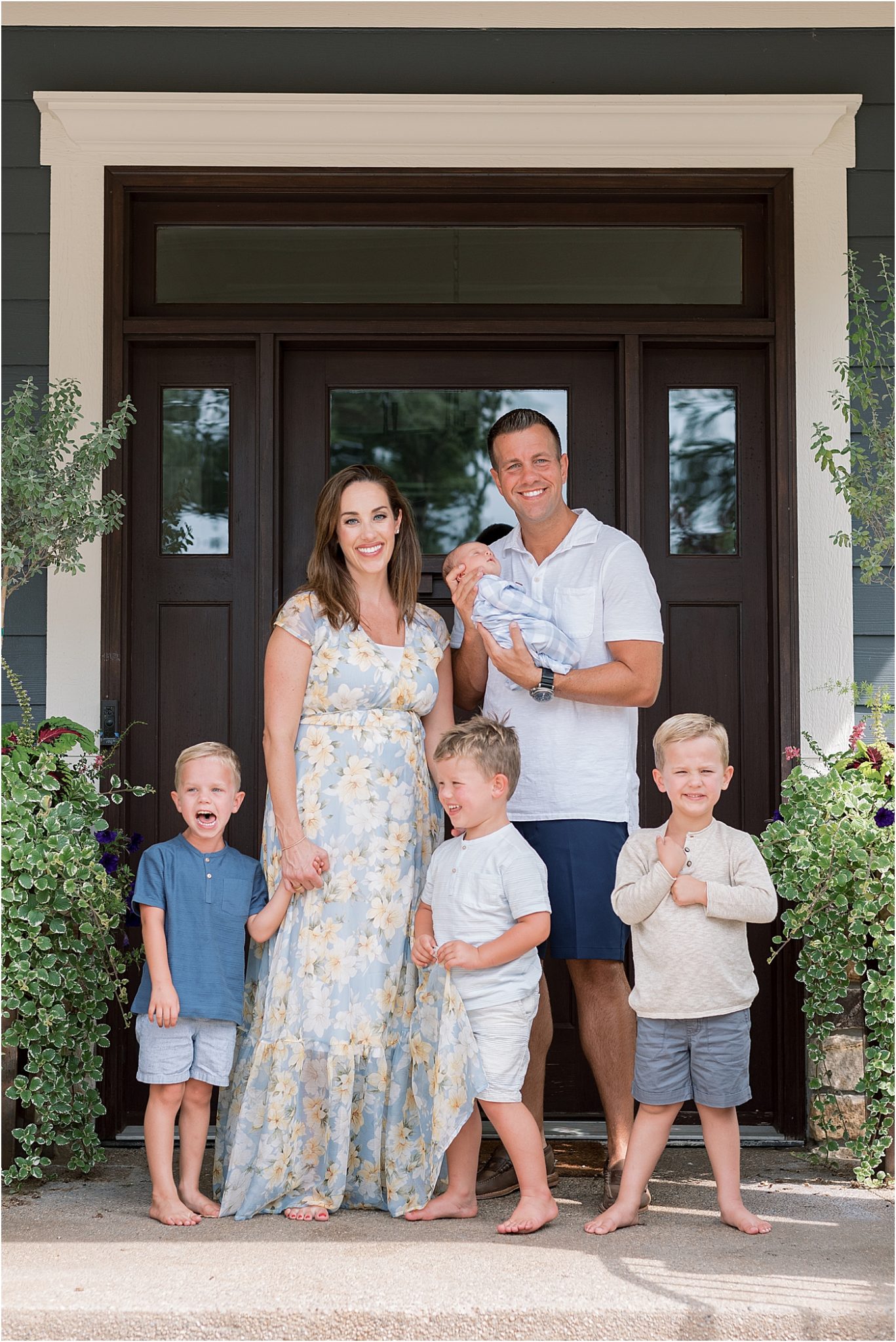 Family outside their home in Carmel Indiana for newborn session with Lindsay Konopa Photography.