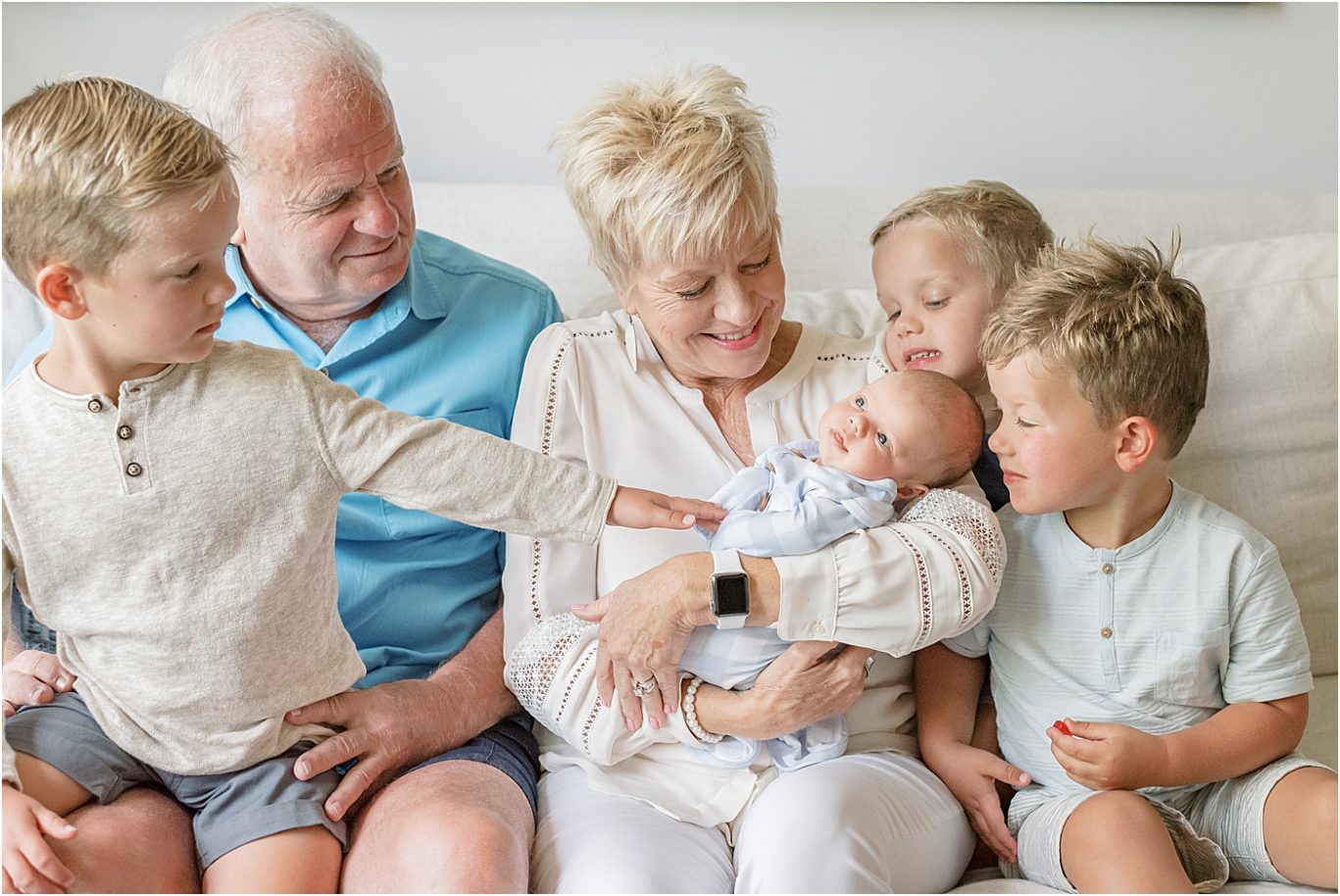 Grandparents with four grandsons during the youngest's newborn session. Photo by Lindsay Konopa Photography.