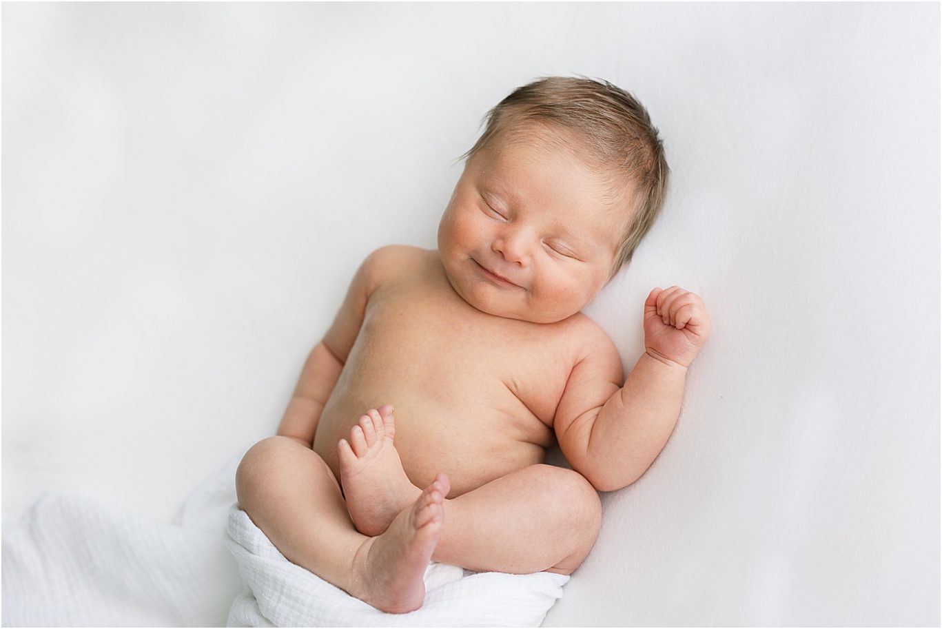 Baby boy smiling during newborn session. Photo by Lindsay Konopa Photography.