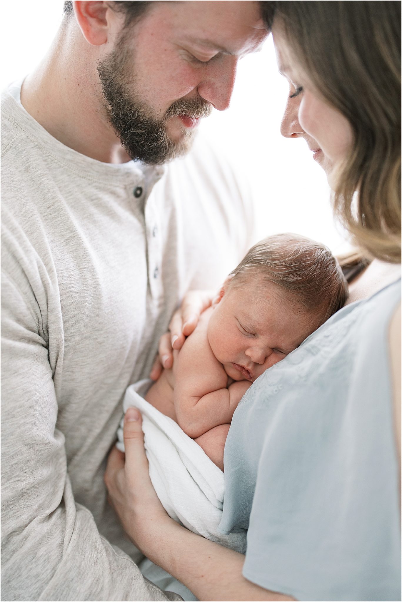 Sweet moment of new parents and their newborn baby boy. Photo by Lindsay Konopa Photography.