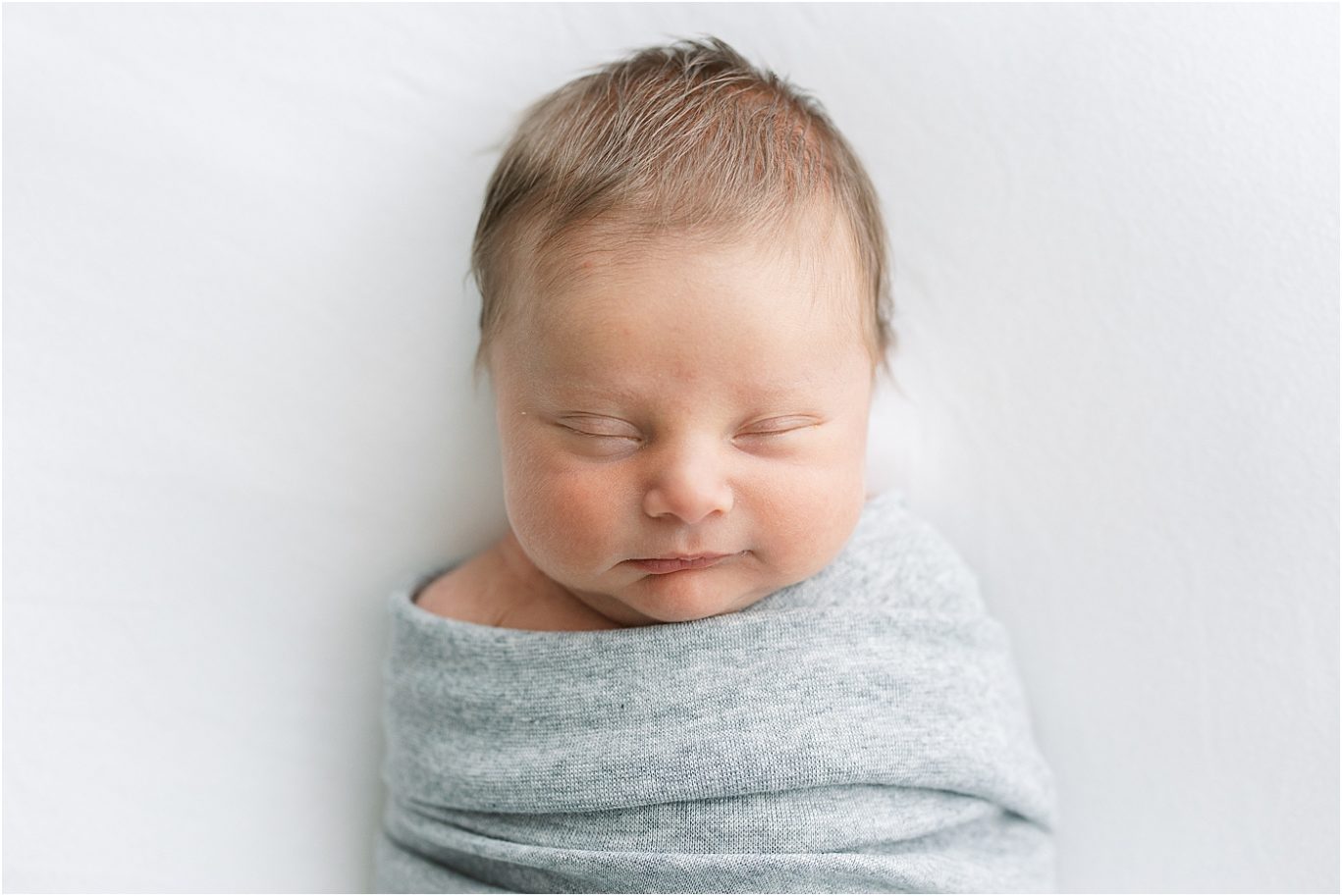 Baby boy sleeping and swaddled for his newborn photos. Photo by Lindsay Konopa Photography.