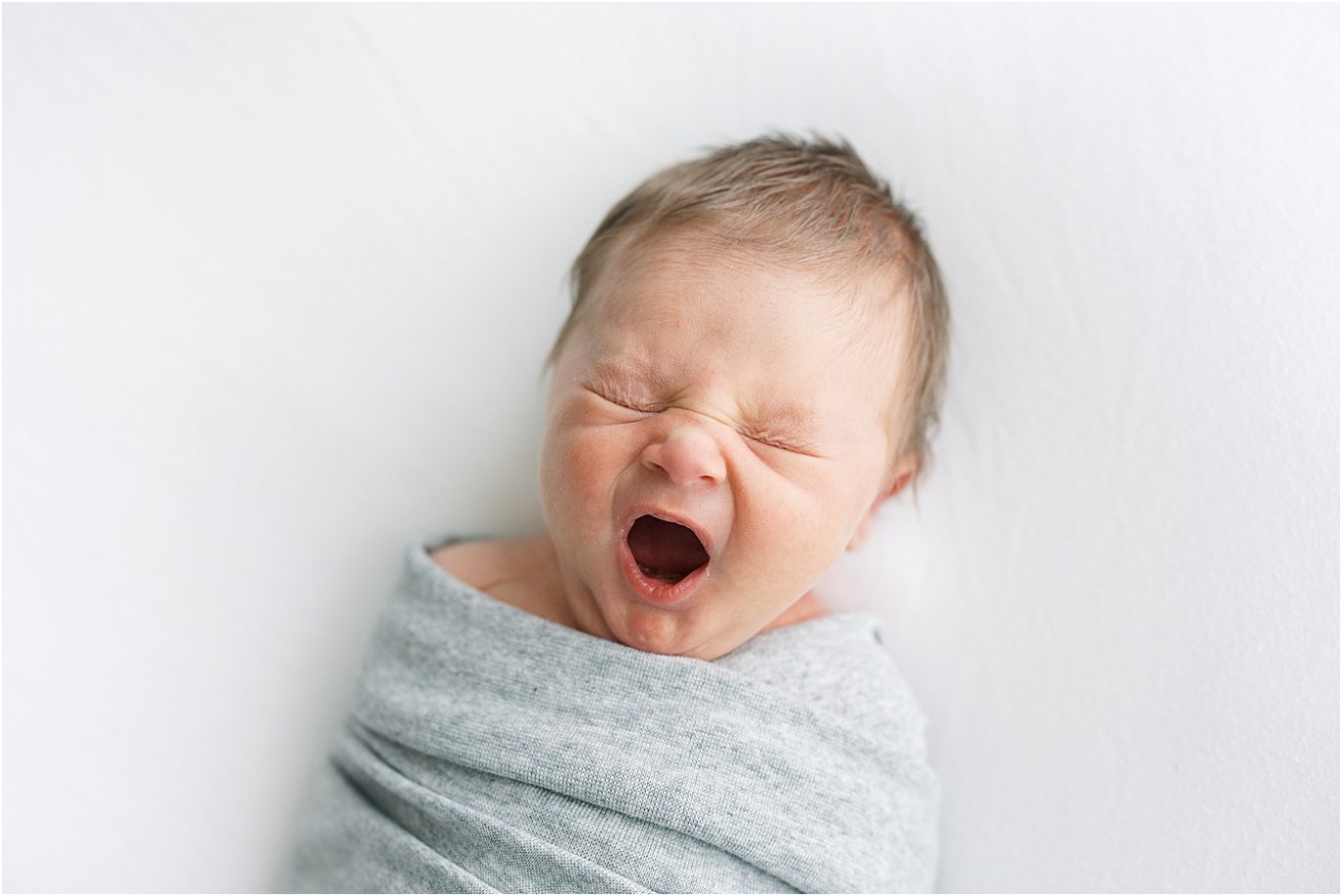Baby yawns during newborn photoshoot. Photo by Lindsay Konopa Photography.