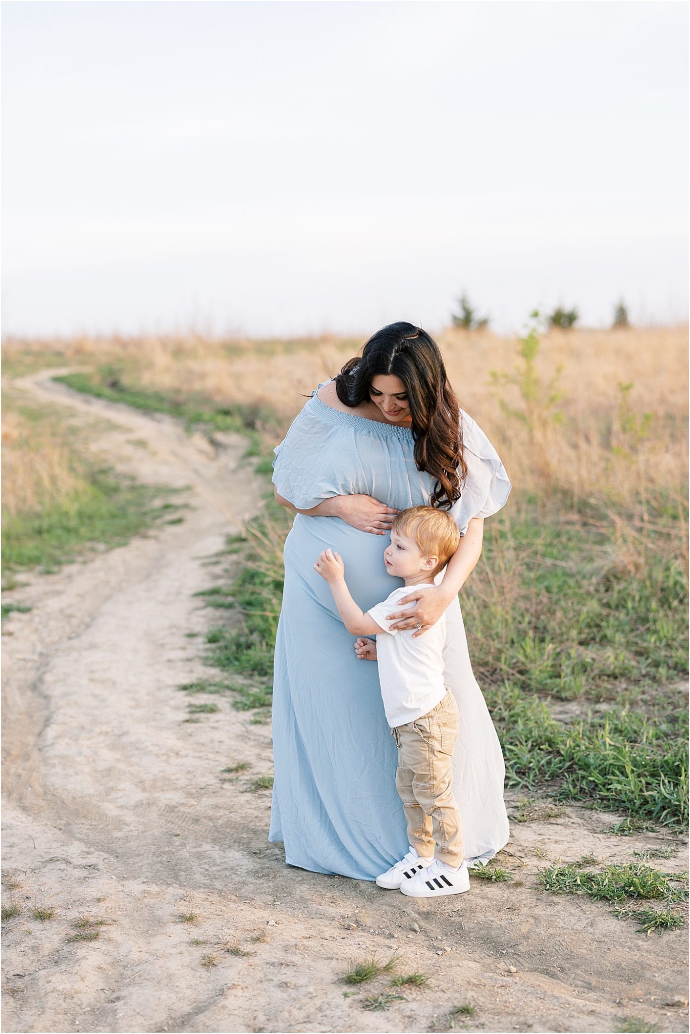 Big brother hugging Mom's belly during maternity session with Lindsay Konopa Photography.