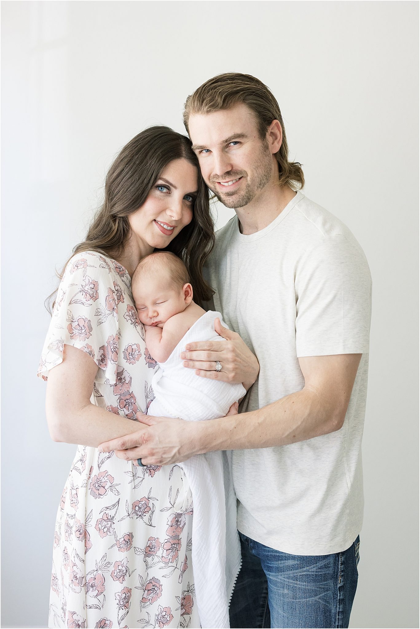 Mom and Dad holding their newborn son in photography studio in Fishers Indiana. Photo by Lindsay Konopa Photography. 
