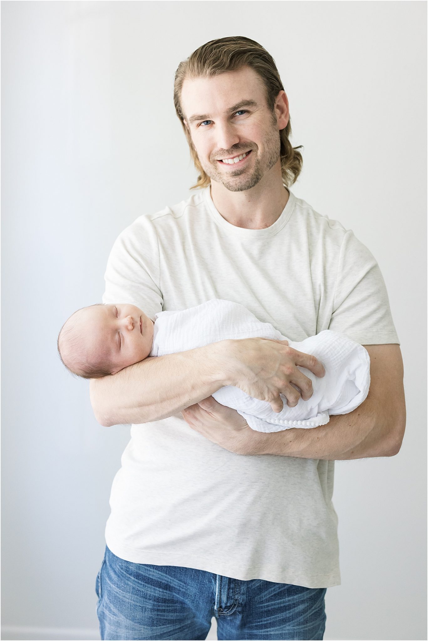 Dad holding his newborn son for photos in studio in Fishers, Indiana | Lindsay Konopa Photography