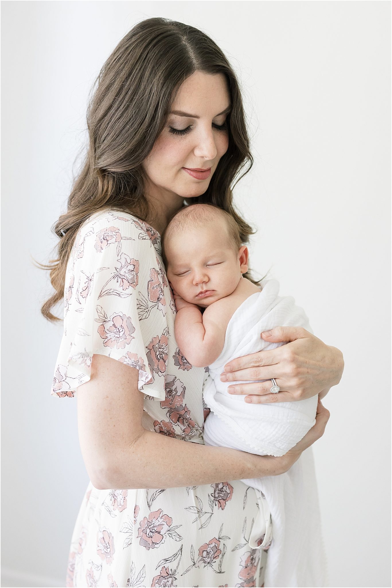 Mom holding newborn son on her chest for photos with Lindsay Konopa Photography.