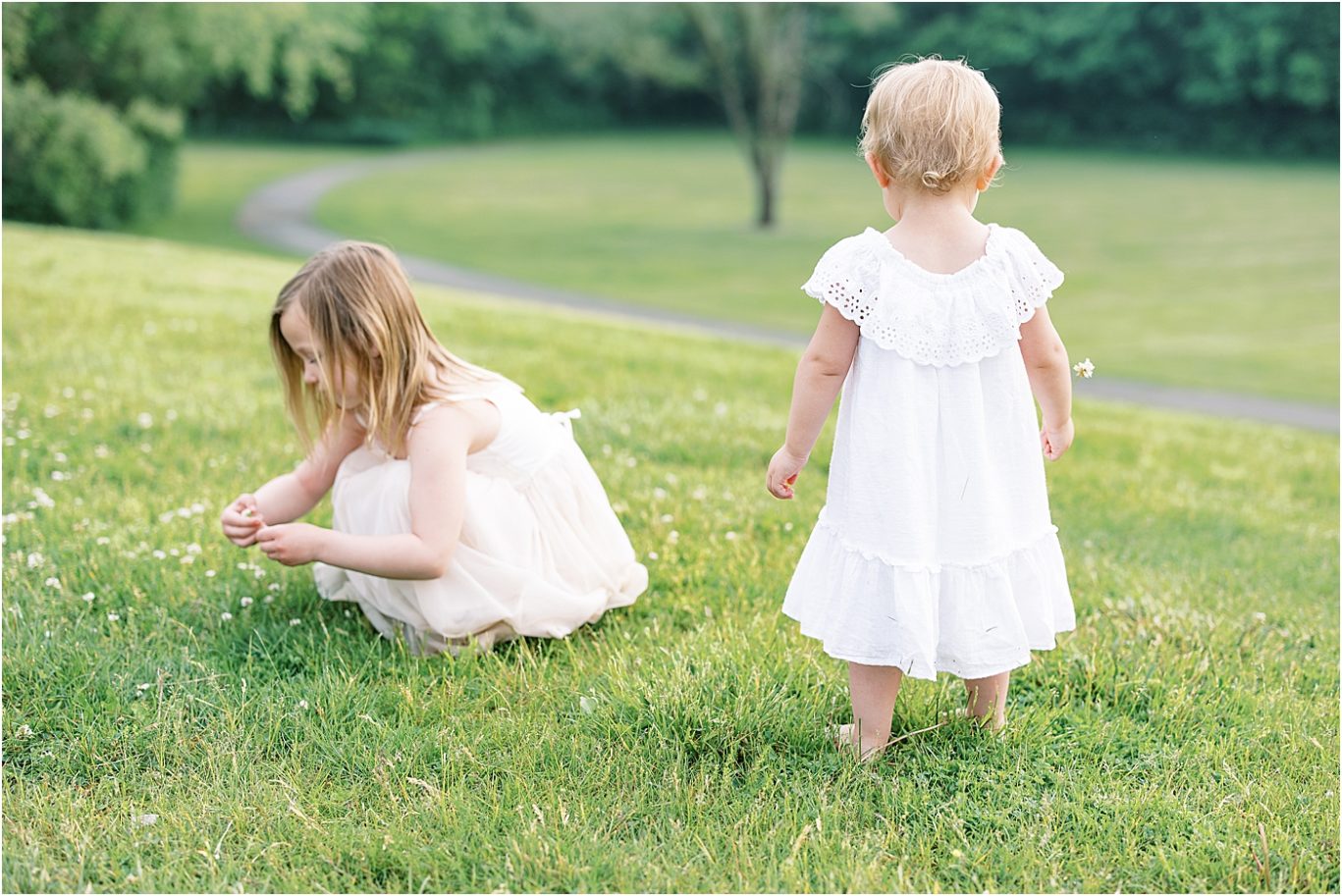 Sisters playing in a field. Photo by Lindsay Konopa Photography.