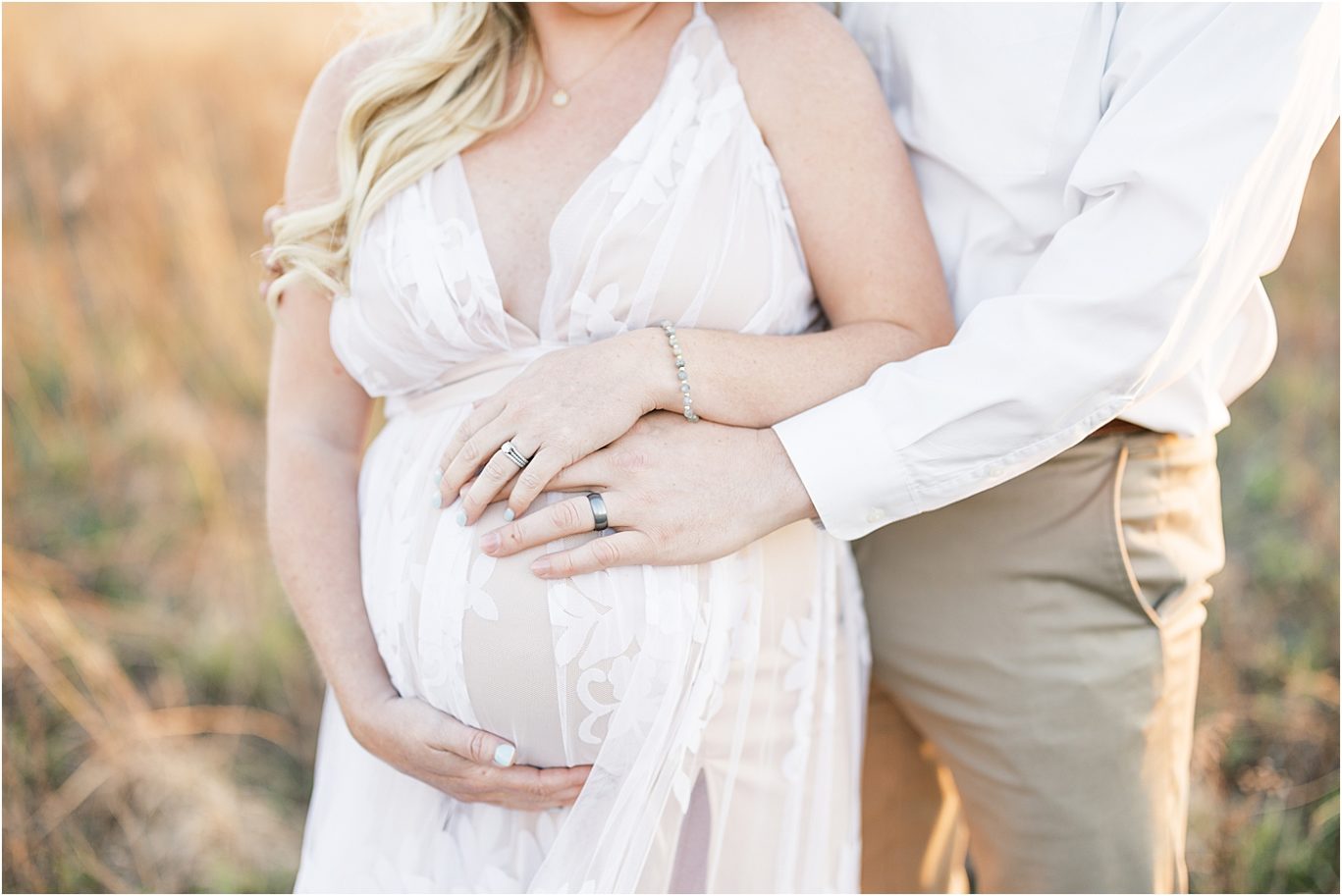 Mom and Dad with hands on her pregnant belly for maternity photos with Lindsay Konopa Photography.