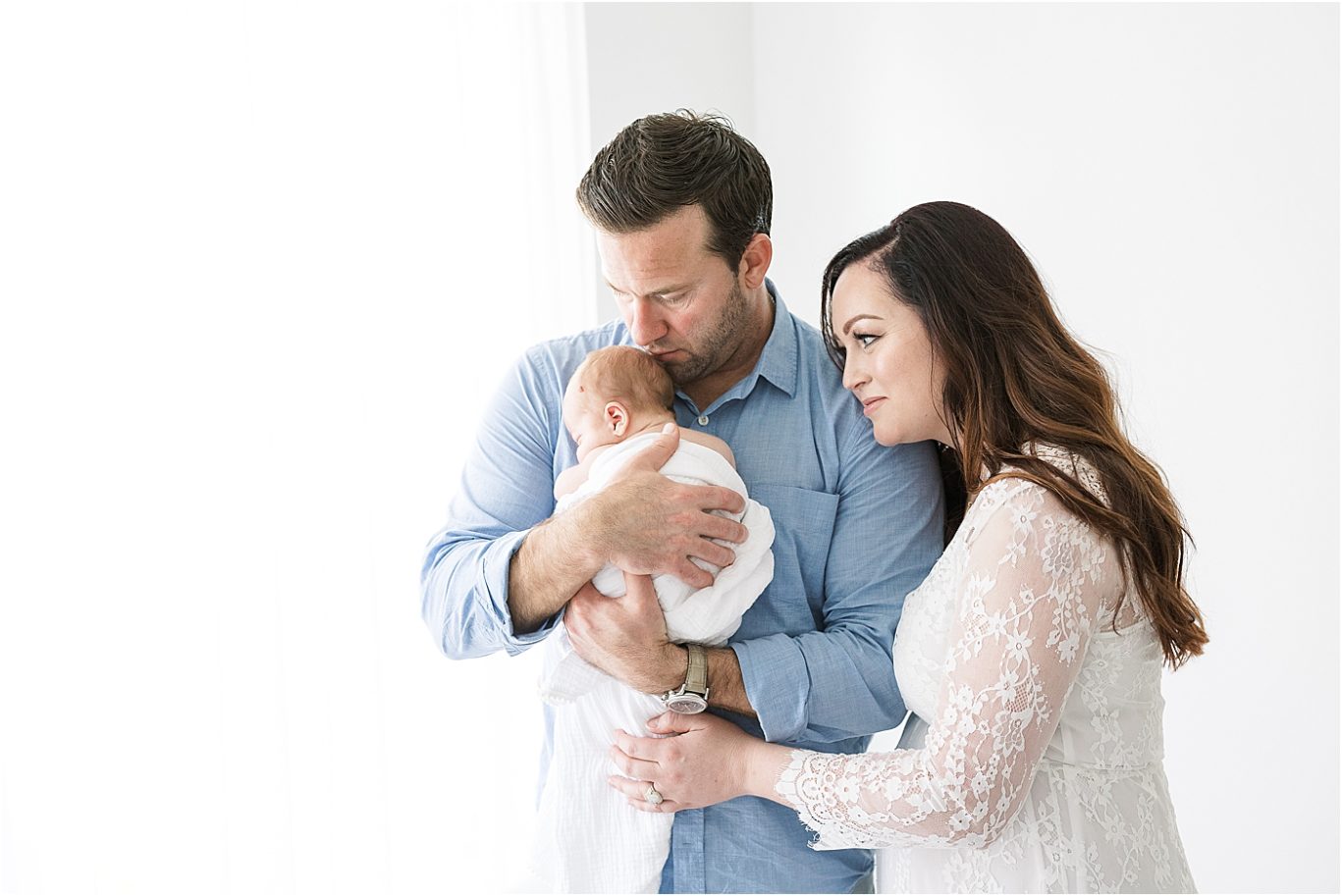 Mom and Dad holding their precious baby boy for newborn photos with Lindsay Konopa Photography.