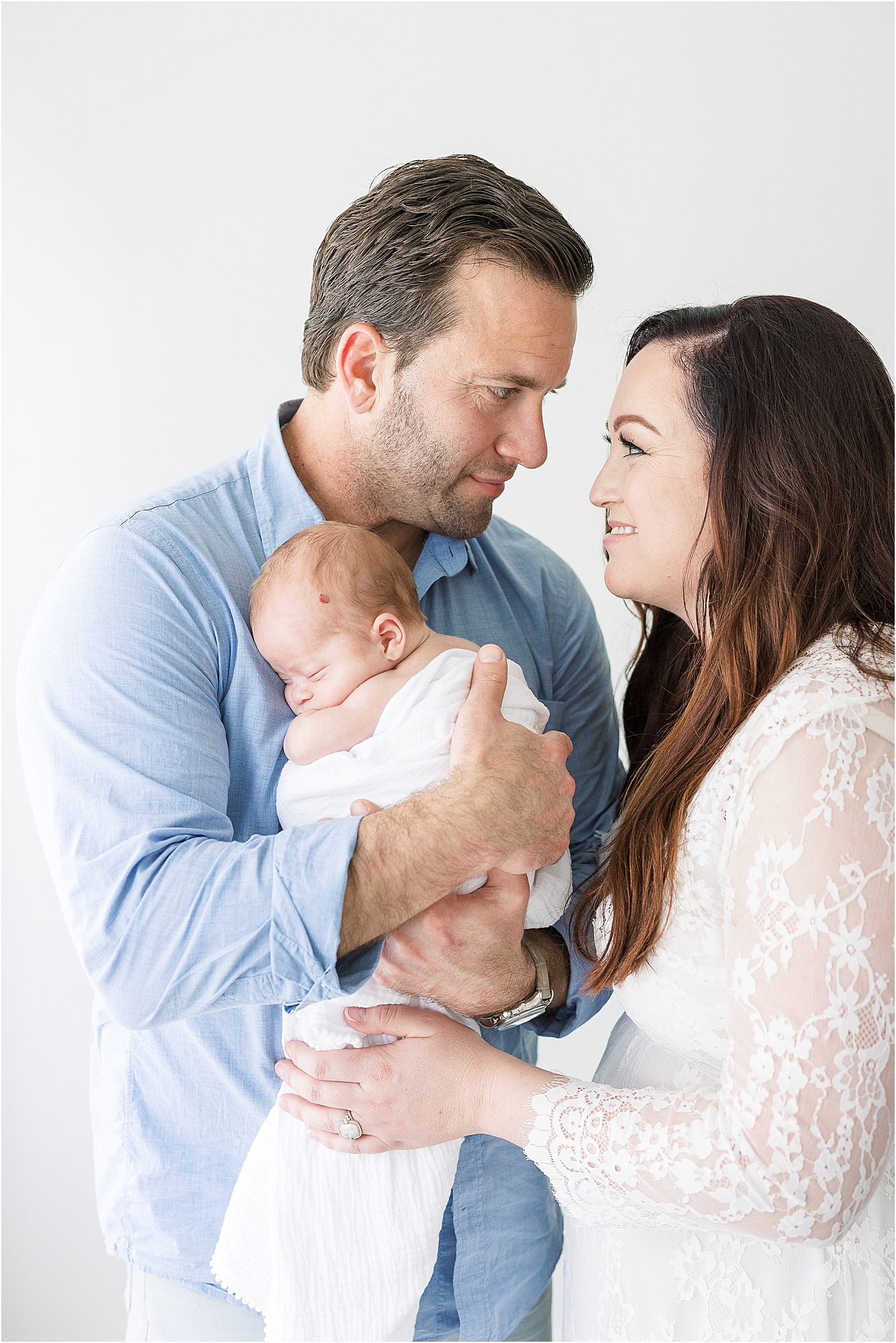 Mom and Dad looking at each other during premie sons newborn session with Lindsay Konopa Photography.