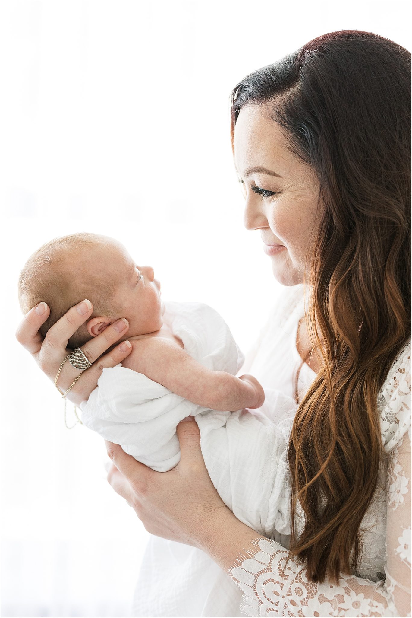 Mother holding her baby boy. Photo by Lindsay Konopa Photography.