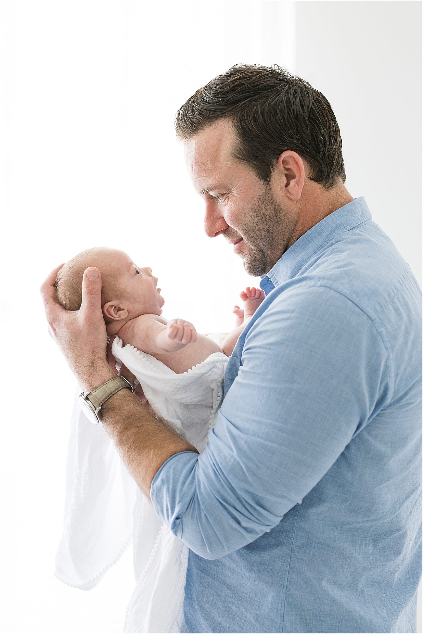 Dad holding his baby boy. Photos by Lindsay Konopa Photography.