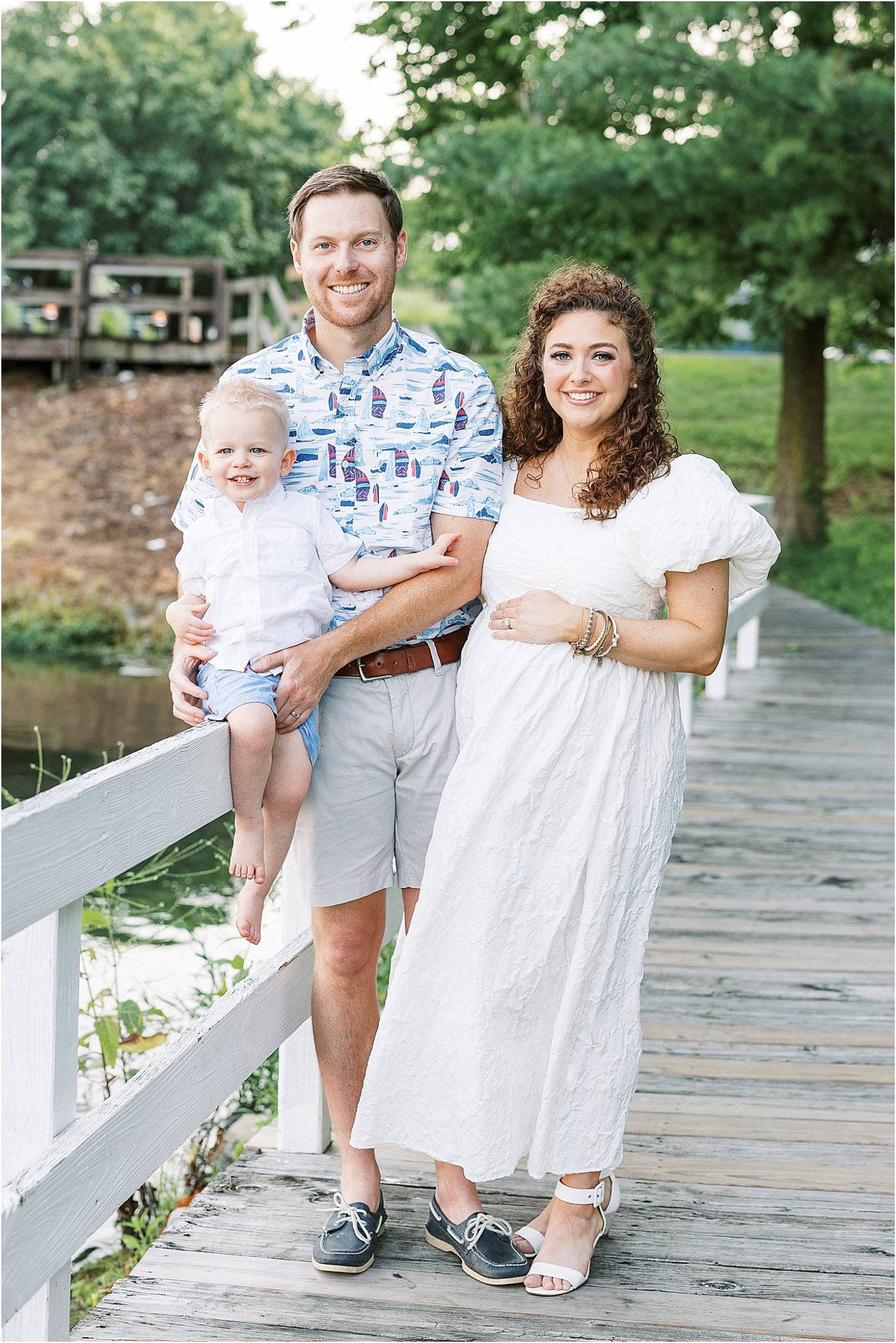 Mom, dad and son at the Geist marina for maternity photoshoot with Lindsay Konopa Photography.