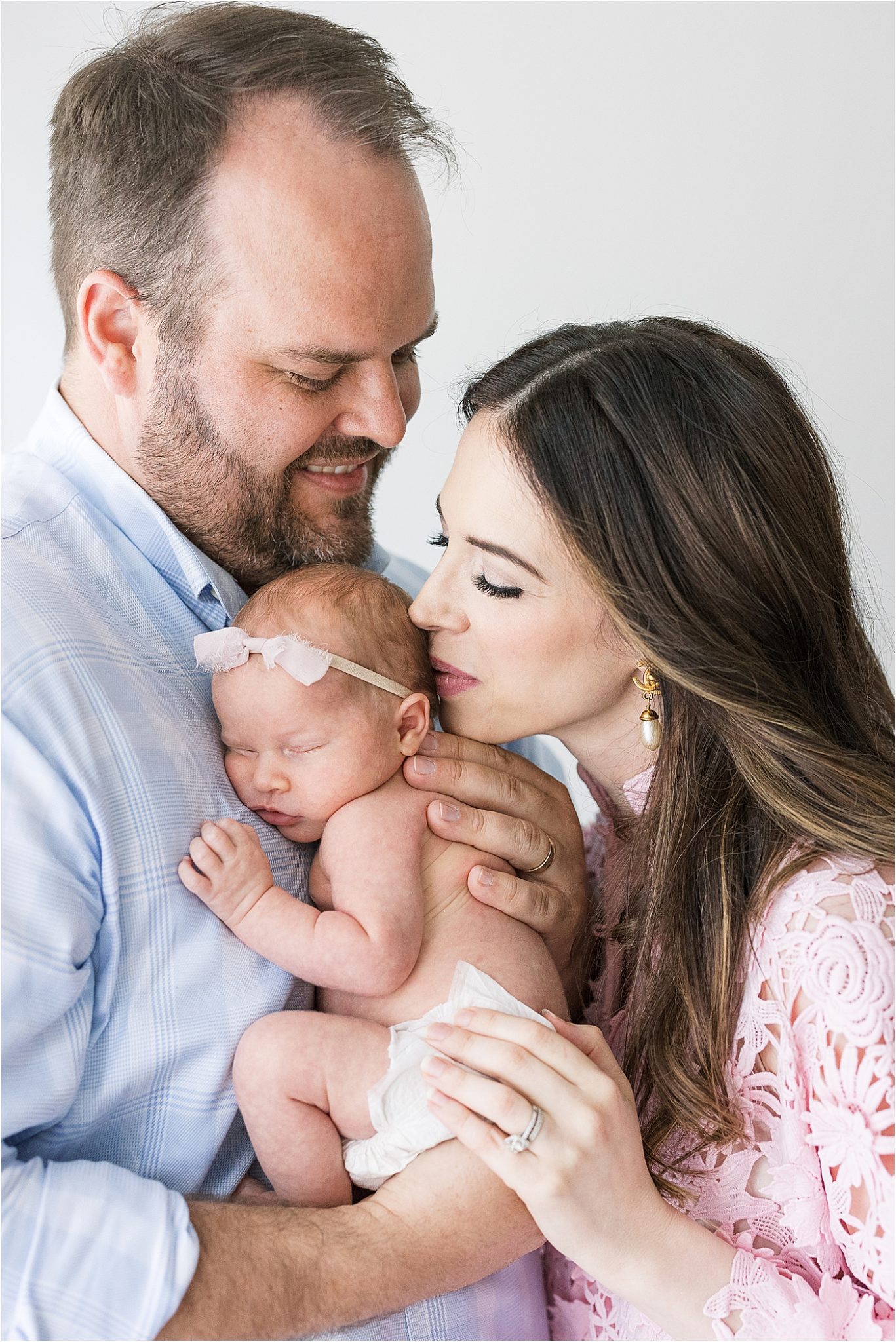 Parents holding newborn baby girl for photoshoot with Lindsay Konopa Photography.