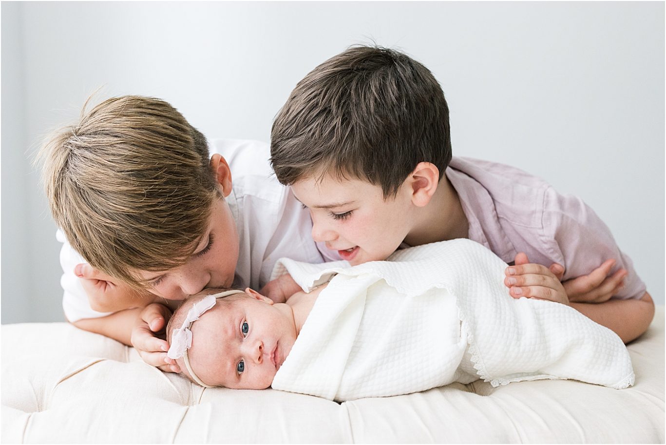 Two big brothers and baby sister during photoshoot with Carmel newborn photographer, Lindsay Konopa Photography.
