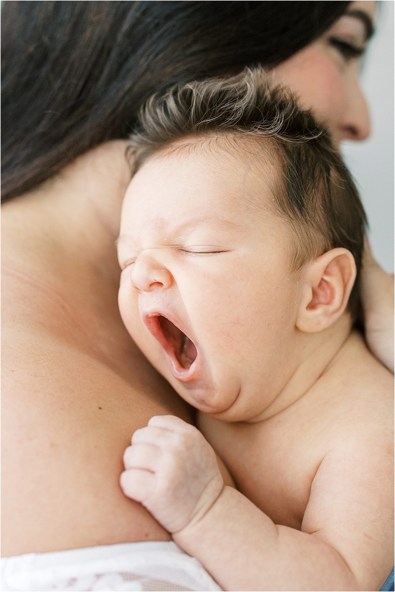 Newborn baby boy yawning during photoshoot with Lindsay Konopa Photography