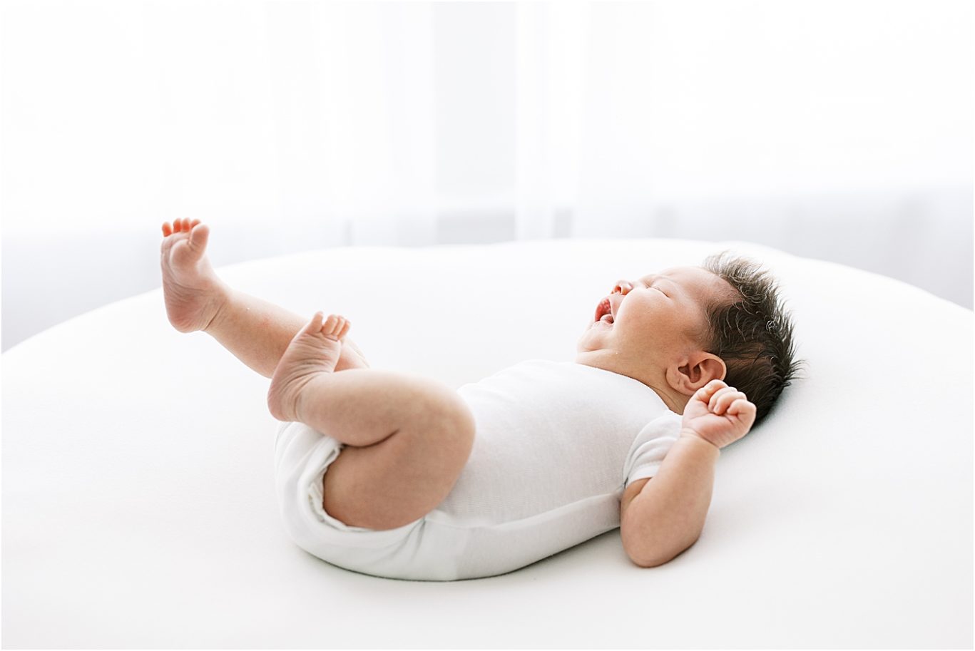 Baby stretching during newborn session with Lindsay Konopa Photography.