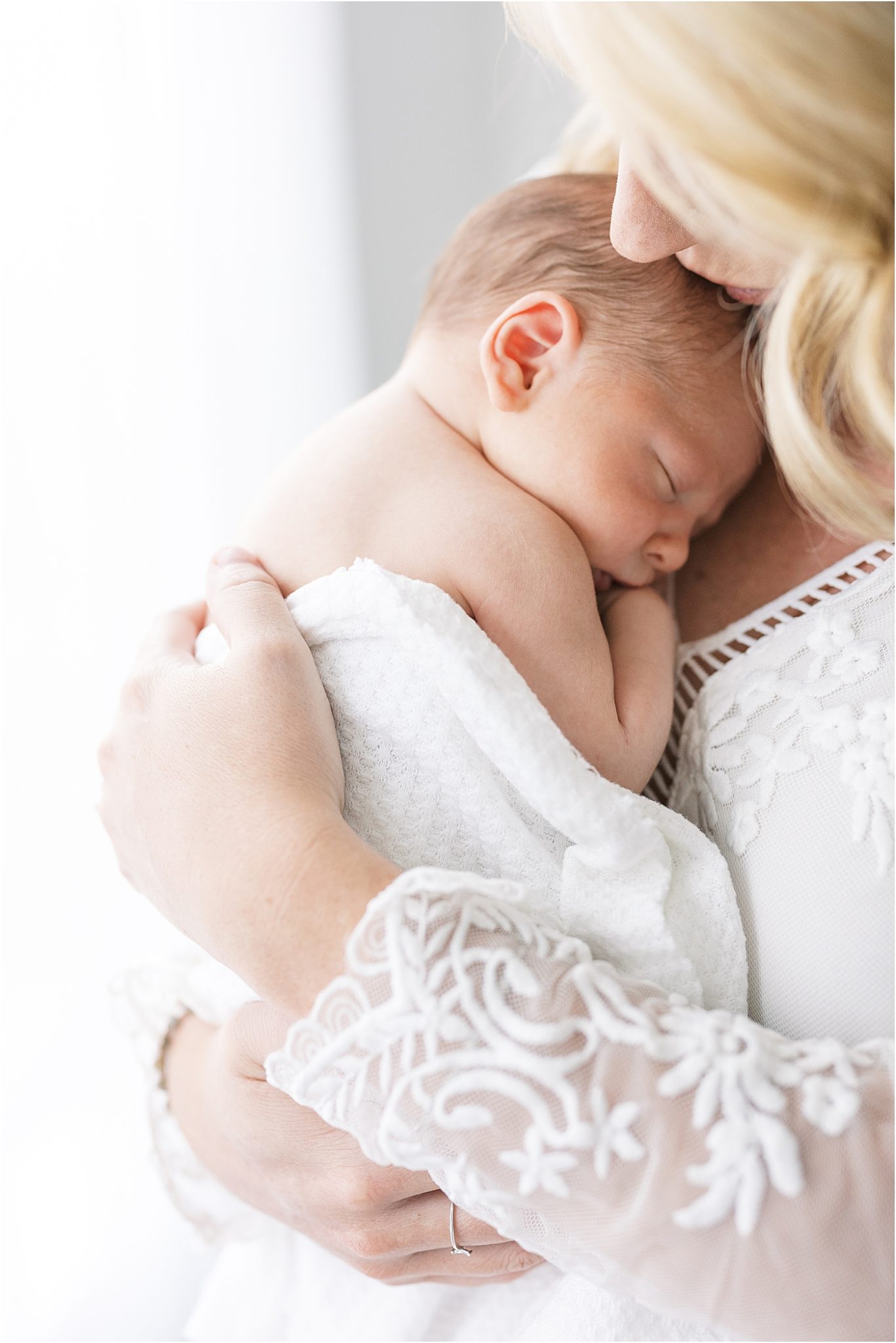 Mom snuggling her sweet boy during newborn session with Lindsay Konopa Photography.