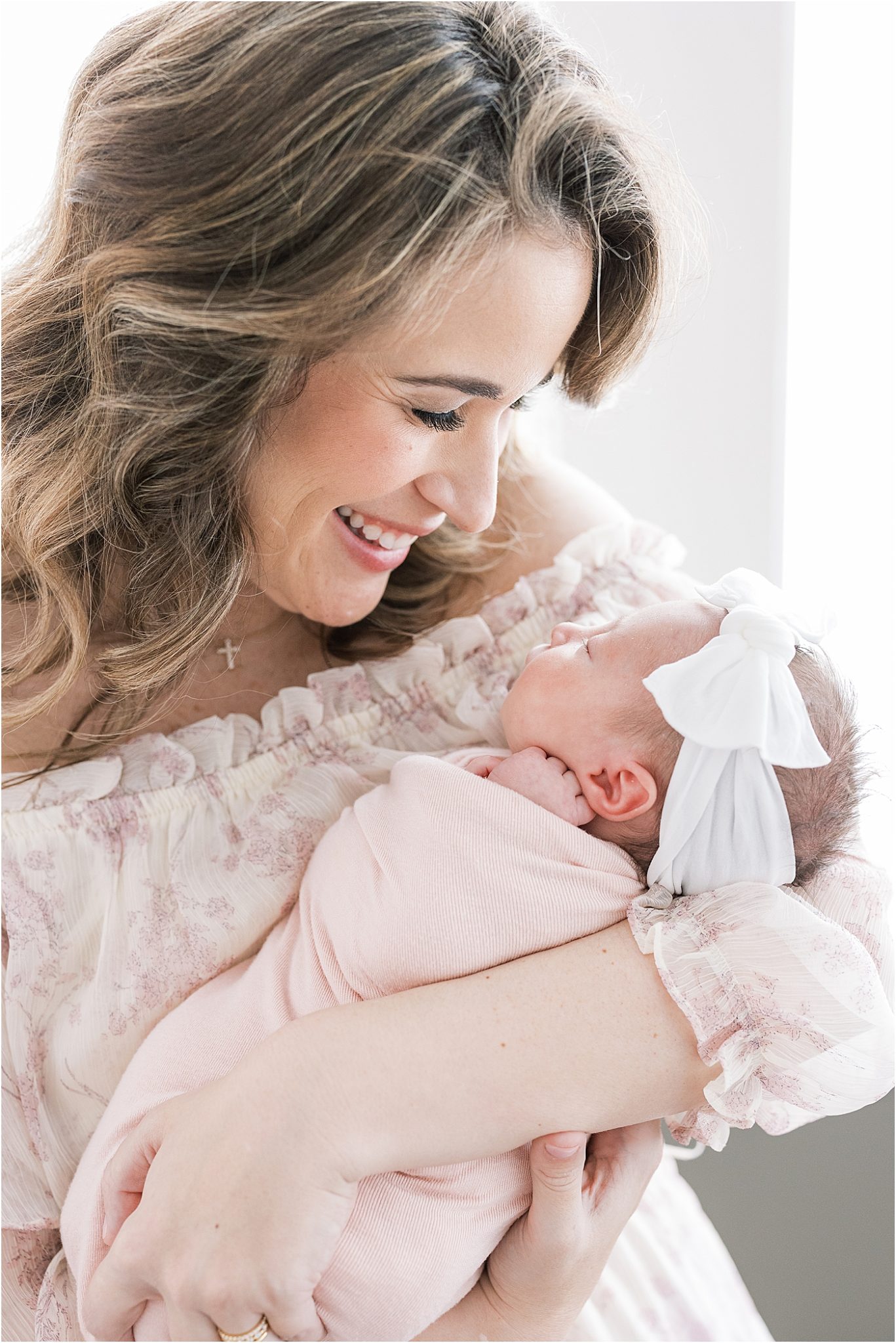 Mom holding baby girl in home for lifestyle newborn session | Lindsay Konopa Photography