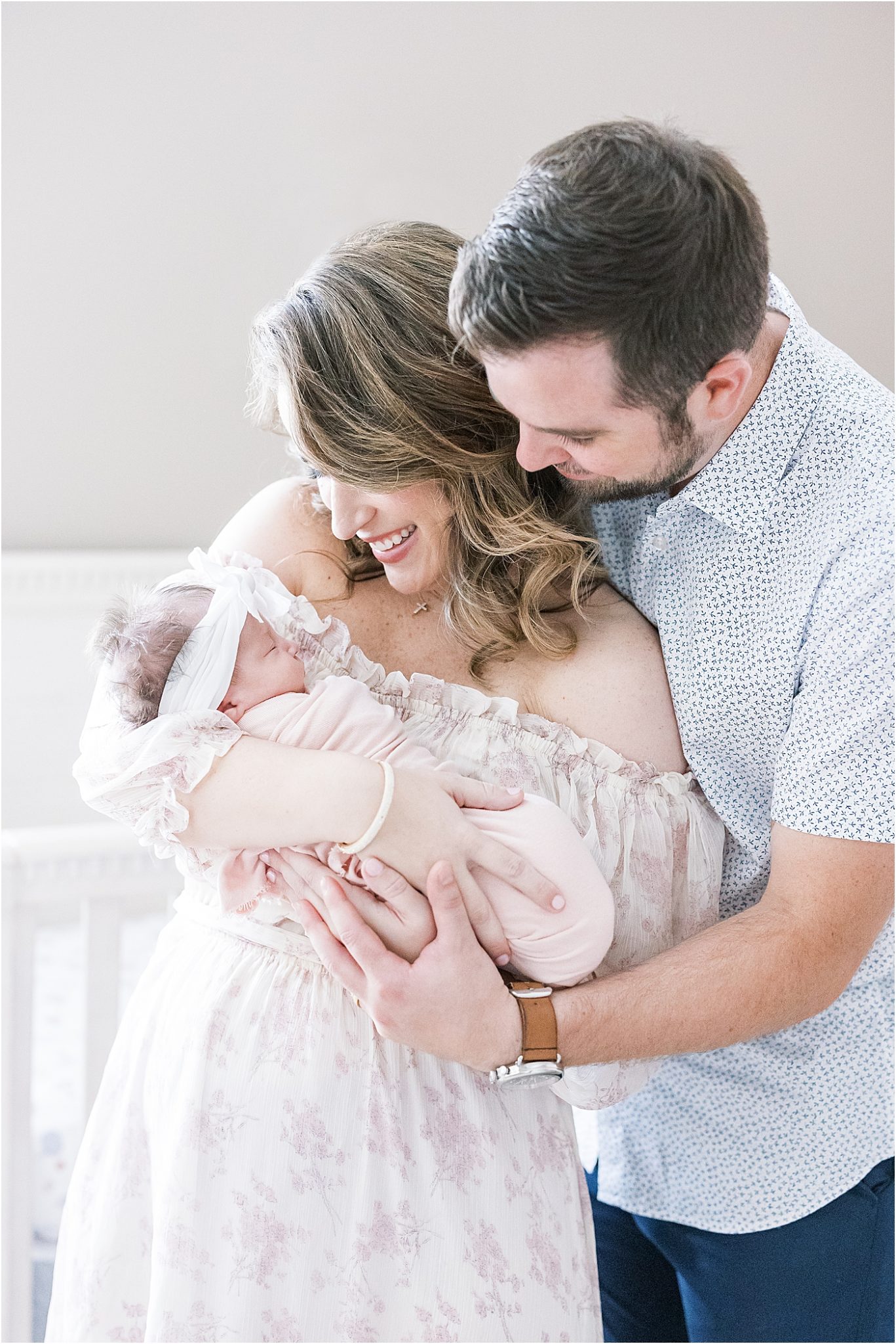 Parents holding their daughter during in-home newborn session with Lindsay Konopa Photography.