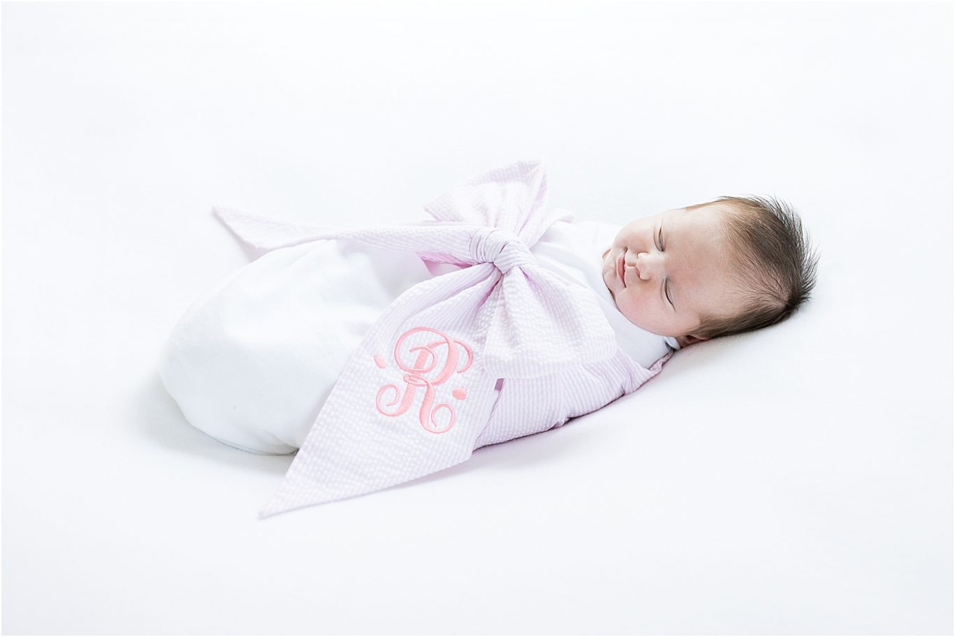 Baby girl swaddled in white with big pink bow | Lindsay Konopa Photography