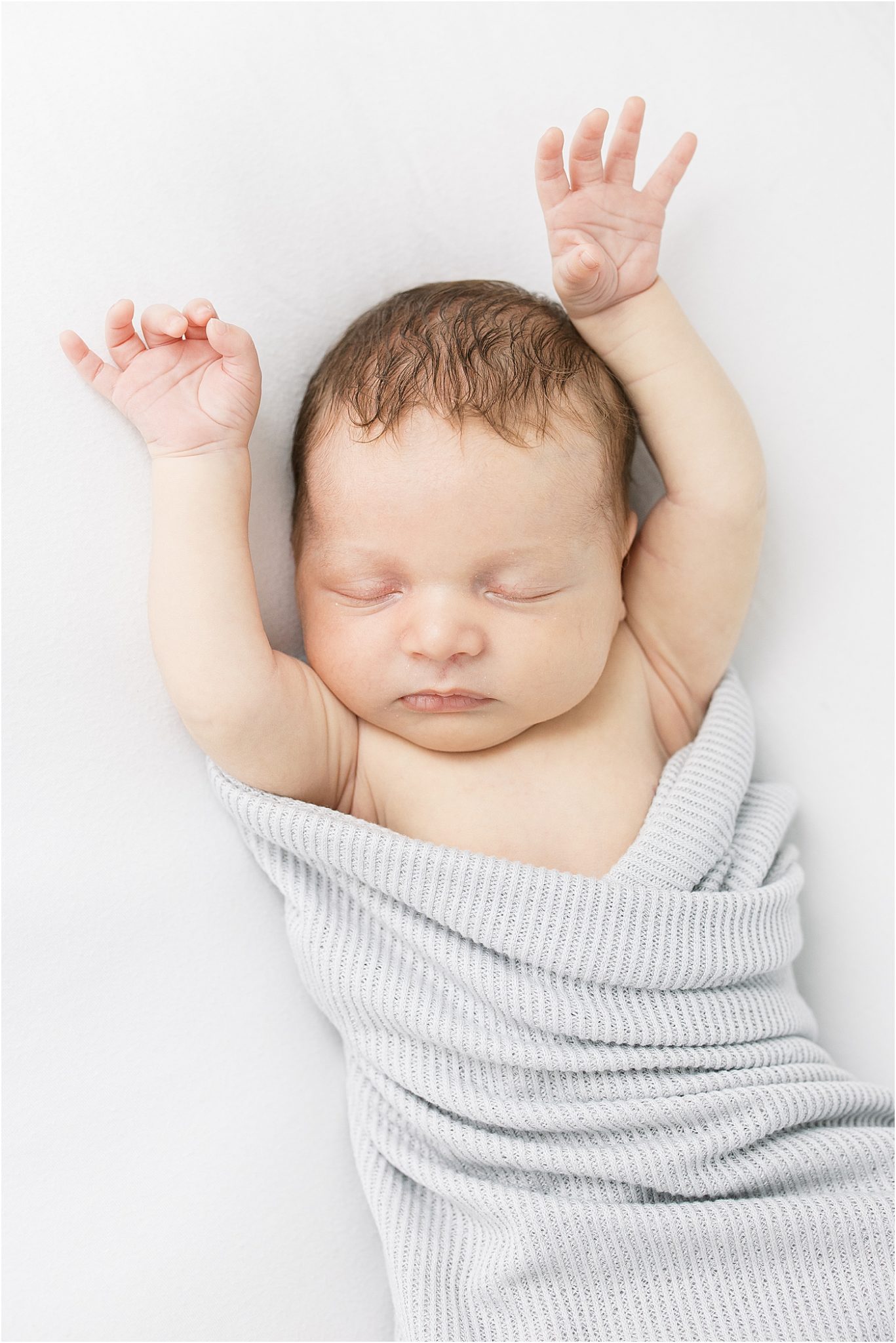 Newborn sleeping with arms up during photoshoot with Lindsay Konopa Photography.