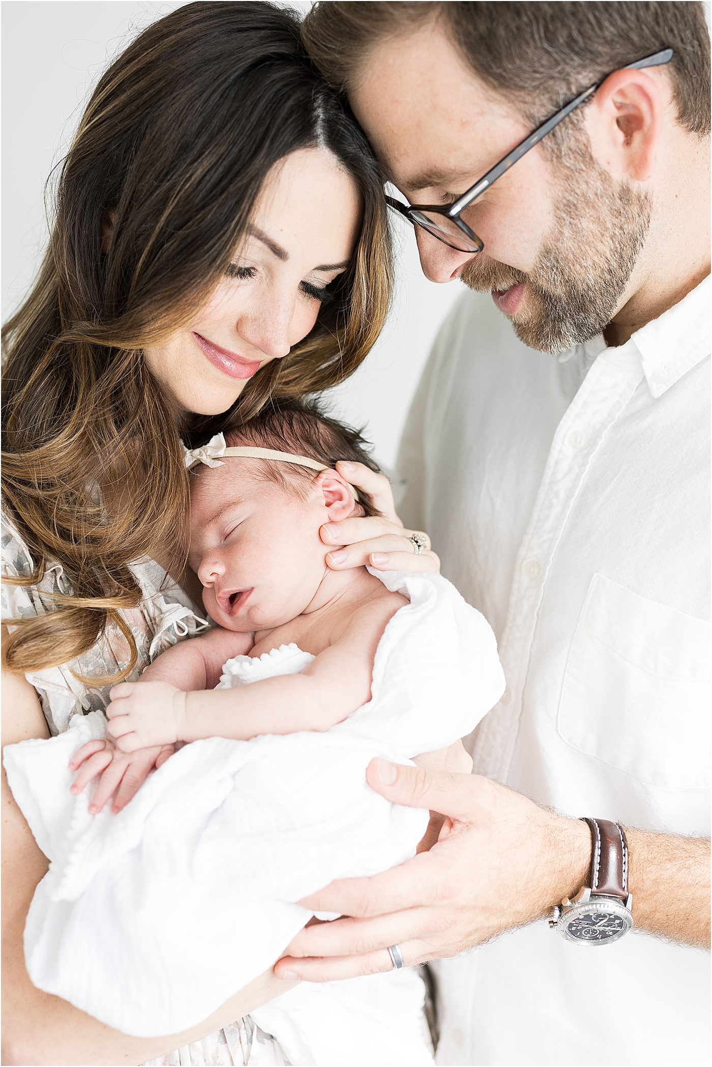 Mom and Dad holding their second baby girl for newborn photos with Lindsay Konopa Photography.