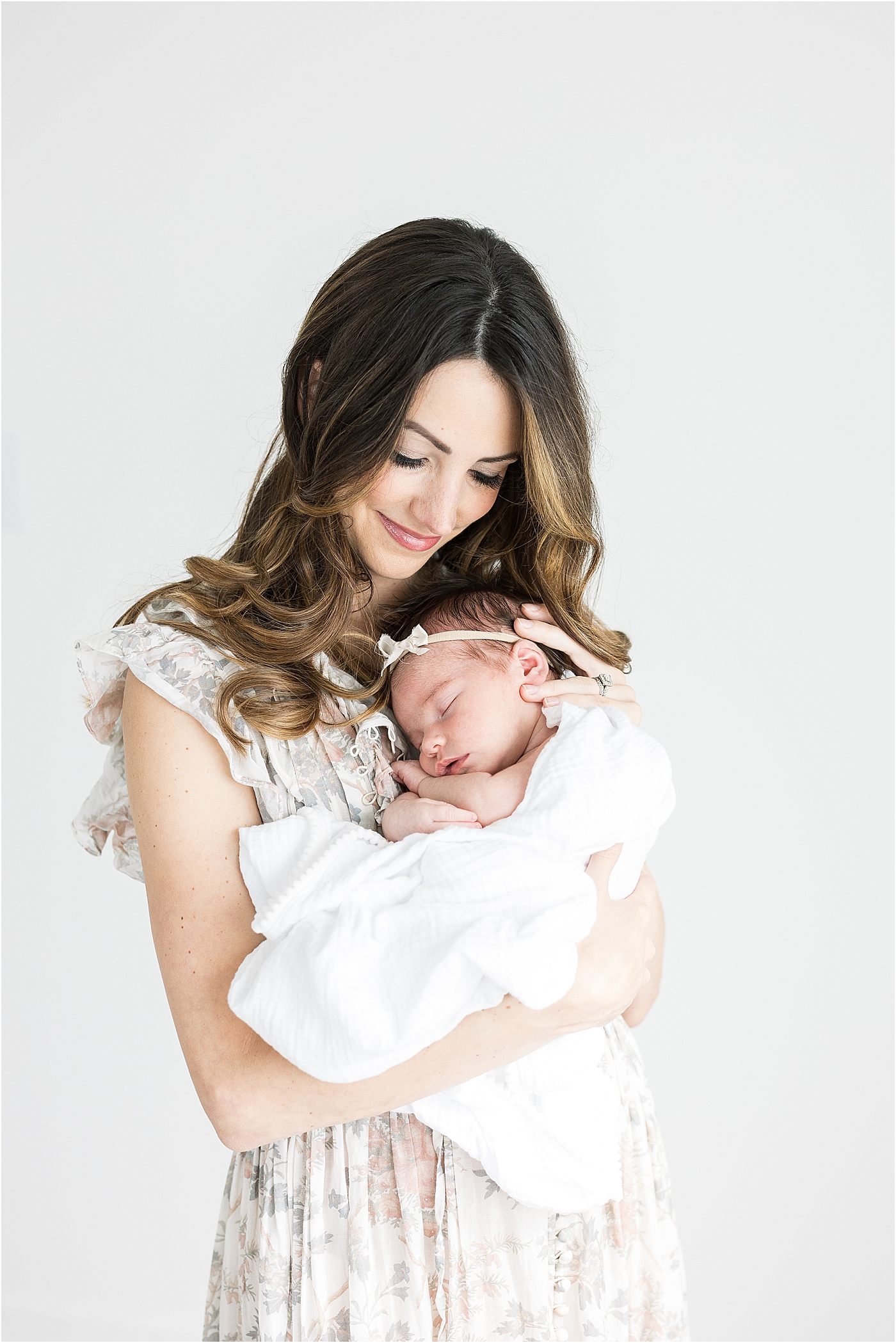 Mom holding her baby girl for newborn photos with Fishers newborn baby photographer, Lindsay Konopa Photography.