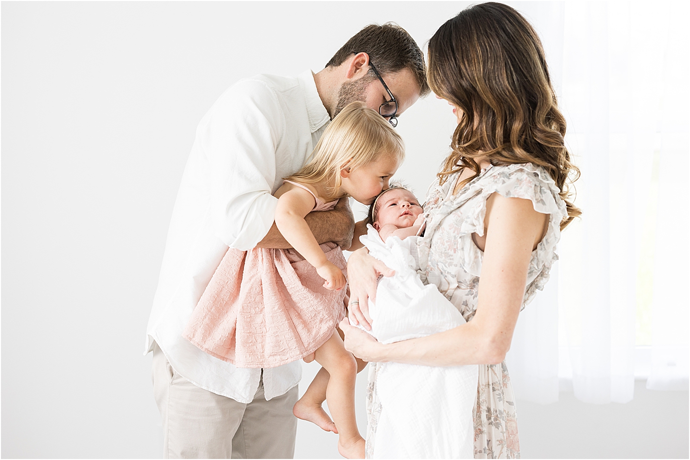 Family of four in studio for newborn photos with Fishers newborn baby photographer, Lindsay Konopa Photography.