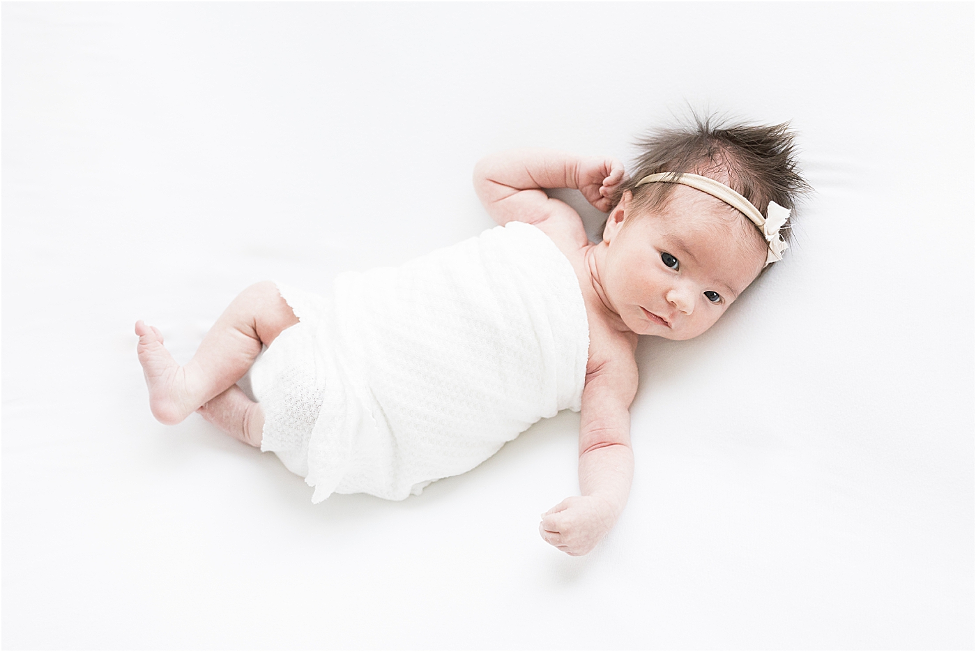 Newborn baby girl wide awake for photos with Lindsay Konopa Photography.