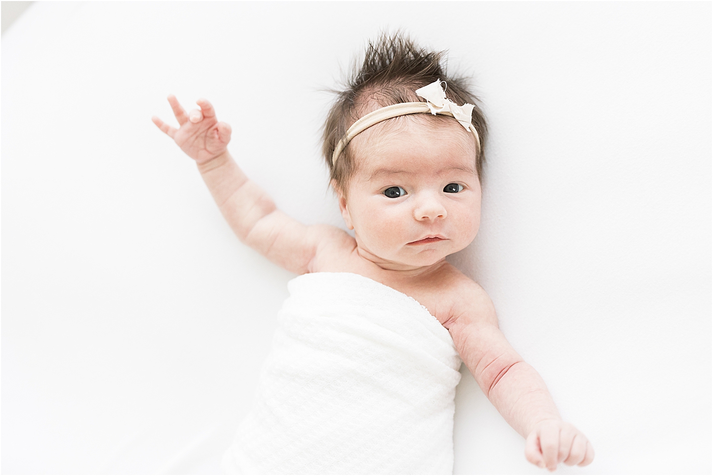 Newborn baby girl wide awake for photos with Lindsay Konopa Photography.