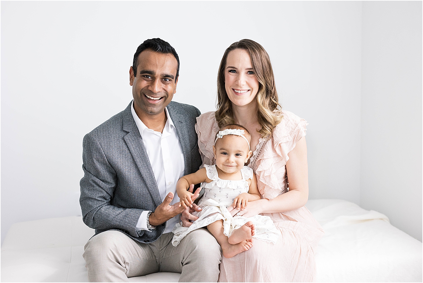 mom, dad, and baby girl pose for first birthday photo session in Fishers, Indiana