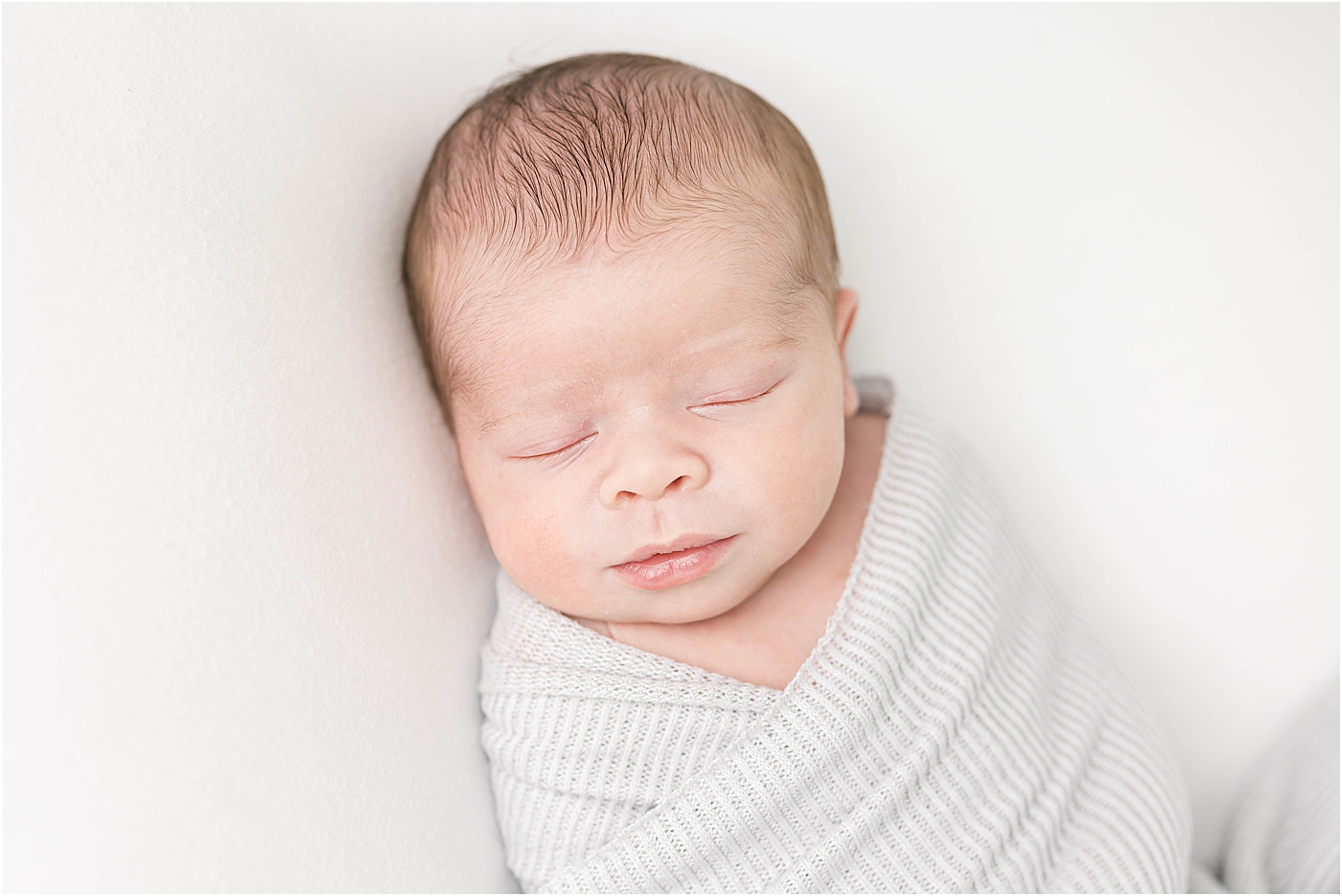 Baby boy swaddled for newborn photos with Lindsay Konopa Photography.