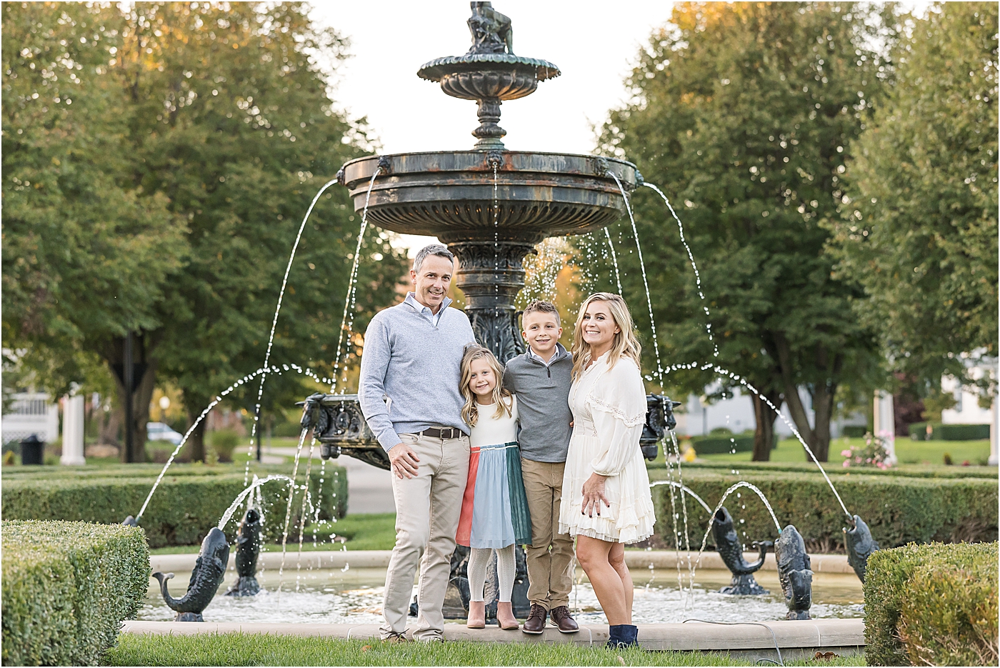 family standing in front of fountain in the Village of WestClay, Carmel, Indiana