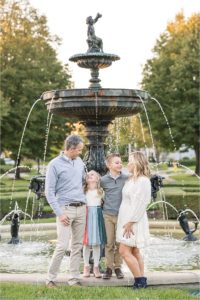 Family standing in front of fountain at The Village of West Clay | Lindsay Konopa Photography