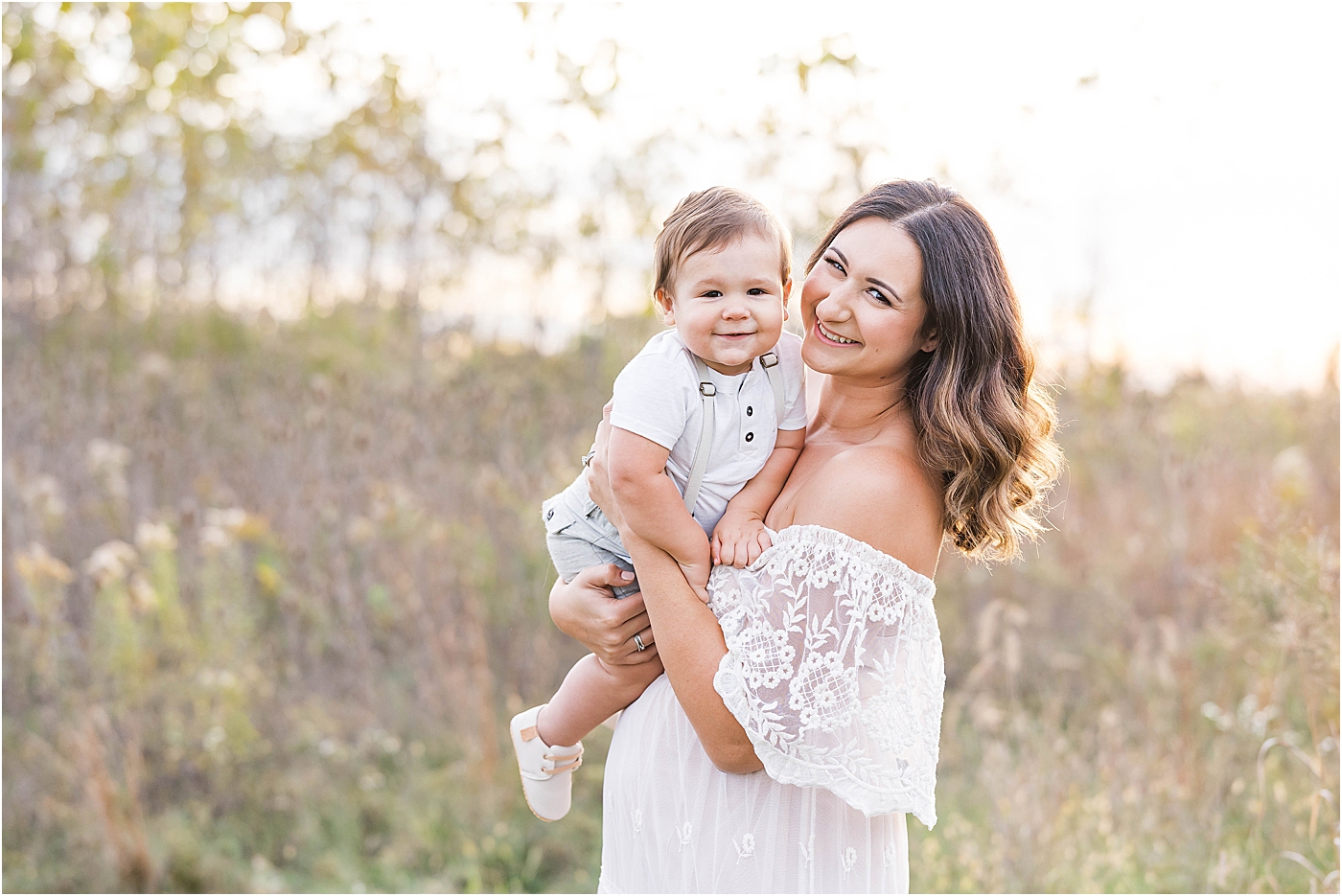 Mom with one year old son during sunset family session with Geist Family Photographer, Lindsay Konopa Photography.
