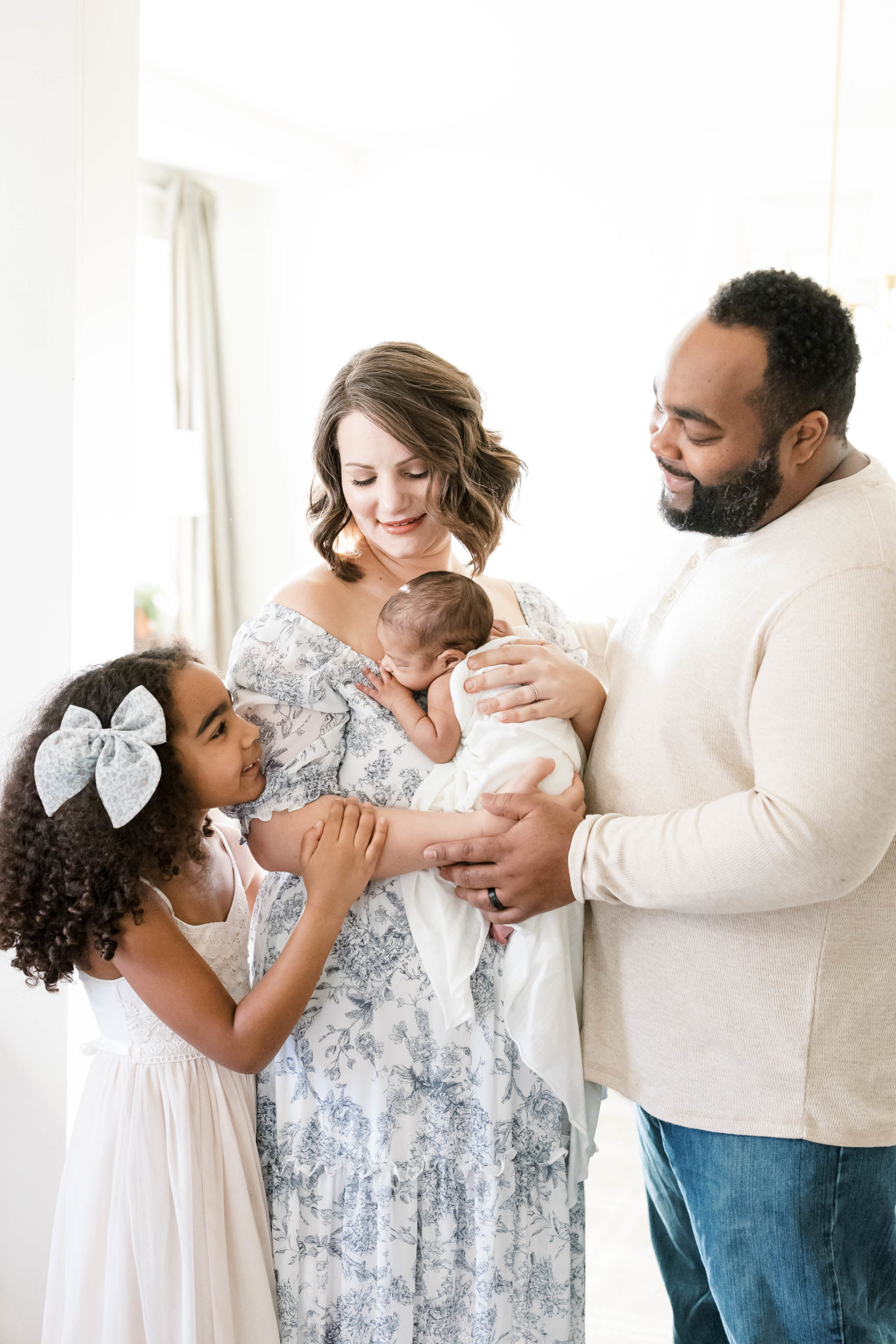 Young family welcomes new baby in their home for a photoshoot